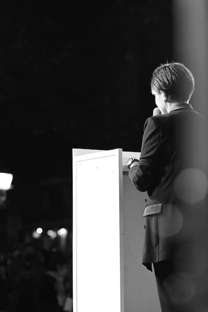 A split image showing the first Academy Awards ceremony in black and white on one side, and a modern, high-definition broadcast of the same event on the other, visually representing the evolution of award shows.