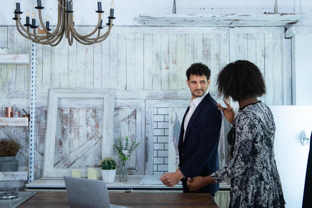 A split-screen image showing two contrasting work environments: on one side, a traditional office with cubicles, and on the other side, a modern, flexible workspace with comfortable seating areas and collaborative spaces. The image illustrates the shift towards more employee-centric work environments.