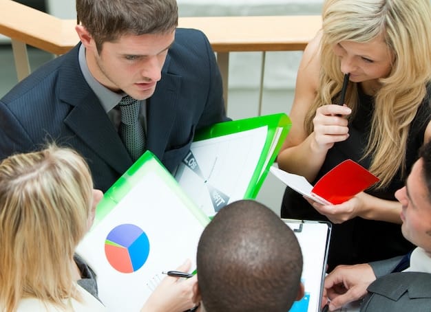 A group of business professionals in a meeting, brainstorming and strategizing around a table with charts and graphs.