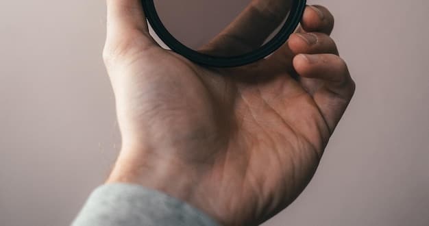A close-up photograph of a hand holding a magnifying glass over a newspaper headline that reads 