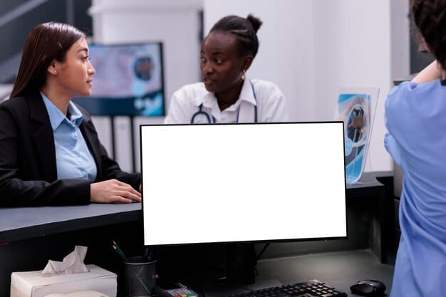 A diverse group of employees attending a healthcare benefits presentation, with a projector screen displaying information about different health plan options.