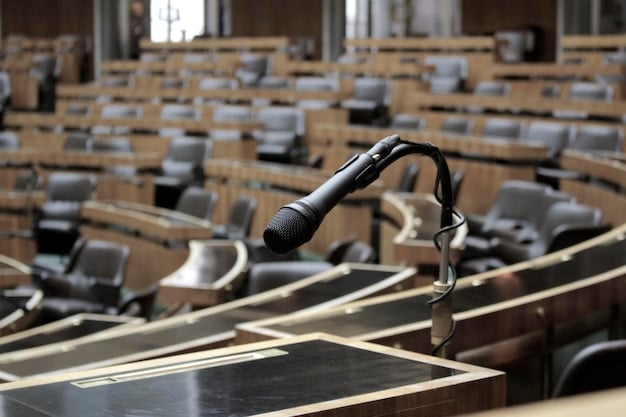 Image of a gavel hitting a sound block in a congressional hearing room, with blurred faces of senators in the background, highlighting the serious and formal nature of the legislative process.