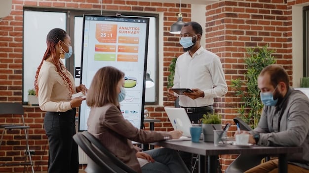 A brand meeting in a modern office, showing diverse employees collaborating around a whiteboard with diagrams of pop culture trends, consumer demographics, and brand strategy ideas, indicating agile marketing.
