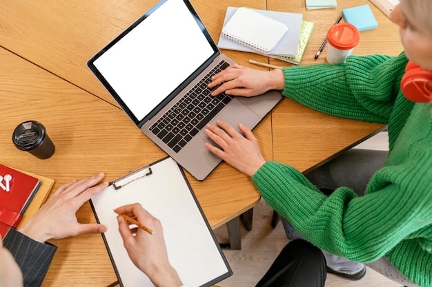 A close-up of hands collaborating to complete a complex grant application form, with a laptop in the background displaying environmental data, symbolizing teamwork and detailed preparation for funding.
