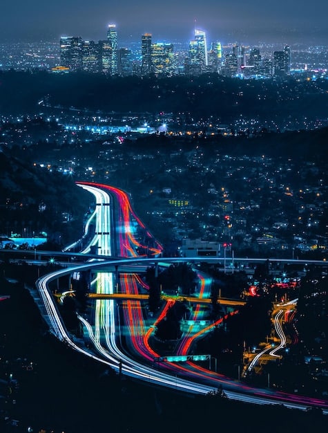 An illuminated smart city skyline at night, crisscrossed by glowing data lines connecting smart traffic lights, autonomous vehicles, and public transport systems, conceptualizing 5G's impact on urban infrastructure.