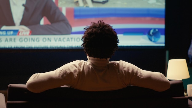 A split image showing on one side a person watching a live sports game on a traditional TV screen, and on the other, a person engaged with a news broadcast, highlighting the continued relevance of live content. The sports side shows a dynamic action shot from a football game, and the news side shows a serious anchor delivering headlines.