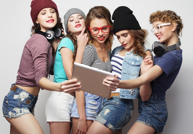 A diverse group of young Americans engaging with K-Pop content on their smartphones and laptops, some wearing K-Pop inspired fashion.