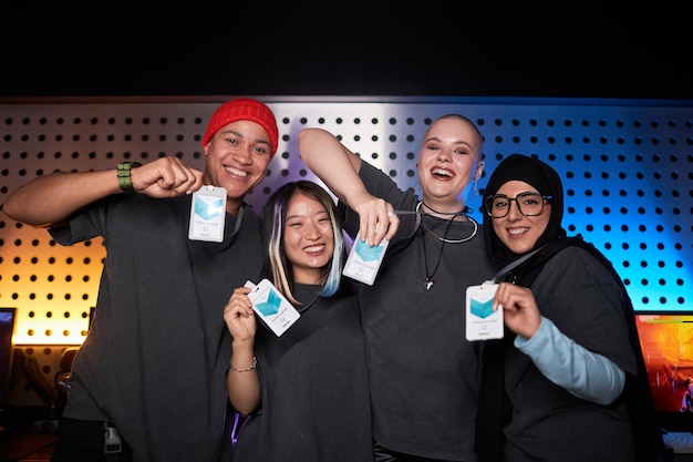 A K-Pop fan wearing branded merchandise at a fan meeting event in the US, holding a lightstick and smiling.