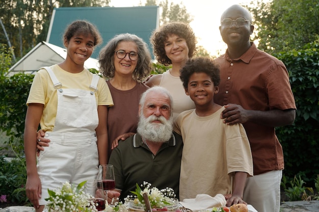 A diverse group of community members, including different ages and ethnicities, participating in a local clean-up event near a river, symbolizing collective action for water stewardship and environmental justice.