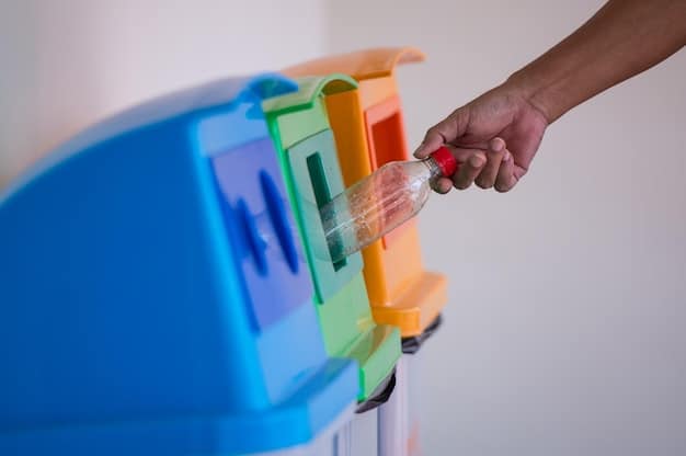 A close-up of a hand placing a recyclable item into a clearly marked recycling bin in a modern office setting.