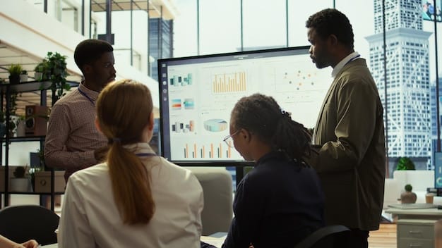 A diverse group of business professionals engaged in a detailed discussion around a table, pointing at charts and digital screens, symbolizing strategic decision-making in M&A.