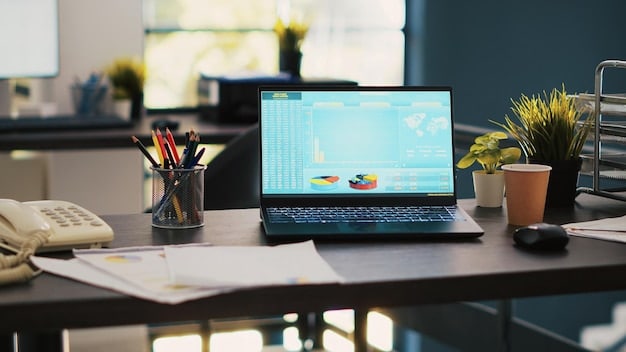 A clean, modern office setting with an empty desk and a laptop displaying vibrant charts and financial data. The overall image gives a sense of efficiency and technological sophistication, hinting at automated financial processes. Natural light streams in, highlighting a calm and organized environment.