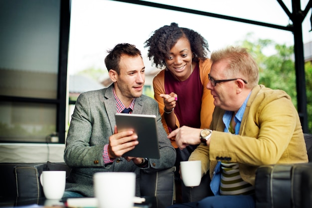 A diverse group of entrepreneurs in a collaborative workspace, excitedly working on laptops and tablets, with a whiteboard in the background displaying creative ideas, symbolizing innovation and new business opportunities.